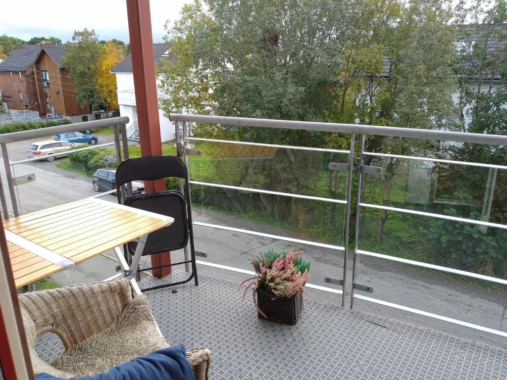 a balcony with a table and chairs and a view of a street at CASA Mama total in Bodø