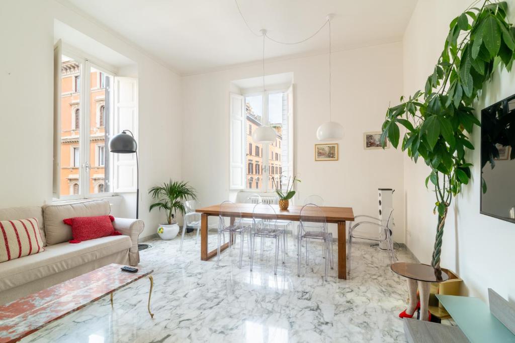 a living room with a table and a couch at Luxury apartment near via veneto in Rome