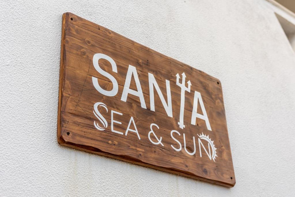 a sign that reads santa seagate seasoning and sun on a wall at Santa, Sea & Sun in Santa Cruz