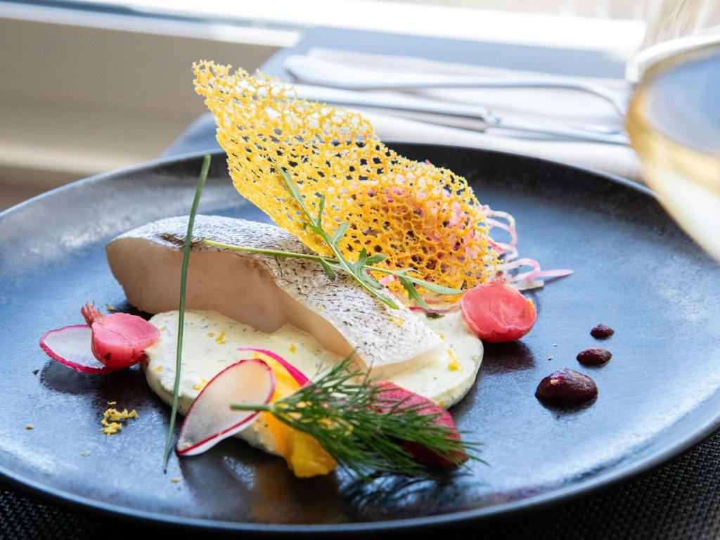 a blue plate with food on a table at Hotel Mercure La Baule Majestic in La Baule