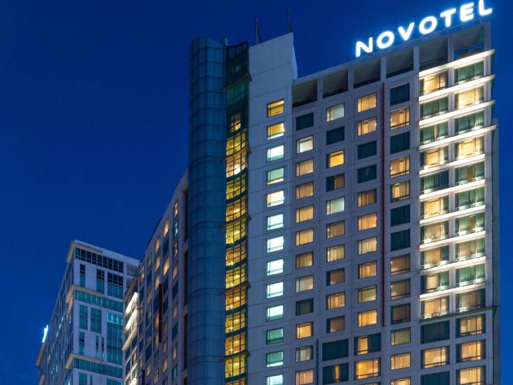 un bâtiment avec le panneau novisor en haut dans l'établissement Novotel Manila Araneta City Hotel, à Manille