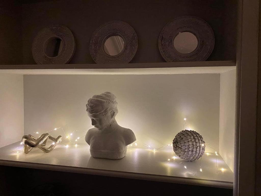 a shelf with a statue of a woman and a golf ball at Harbour Heights Whitby in Whitby