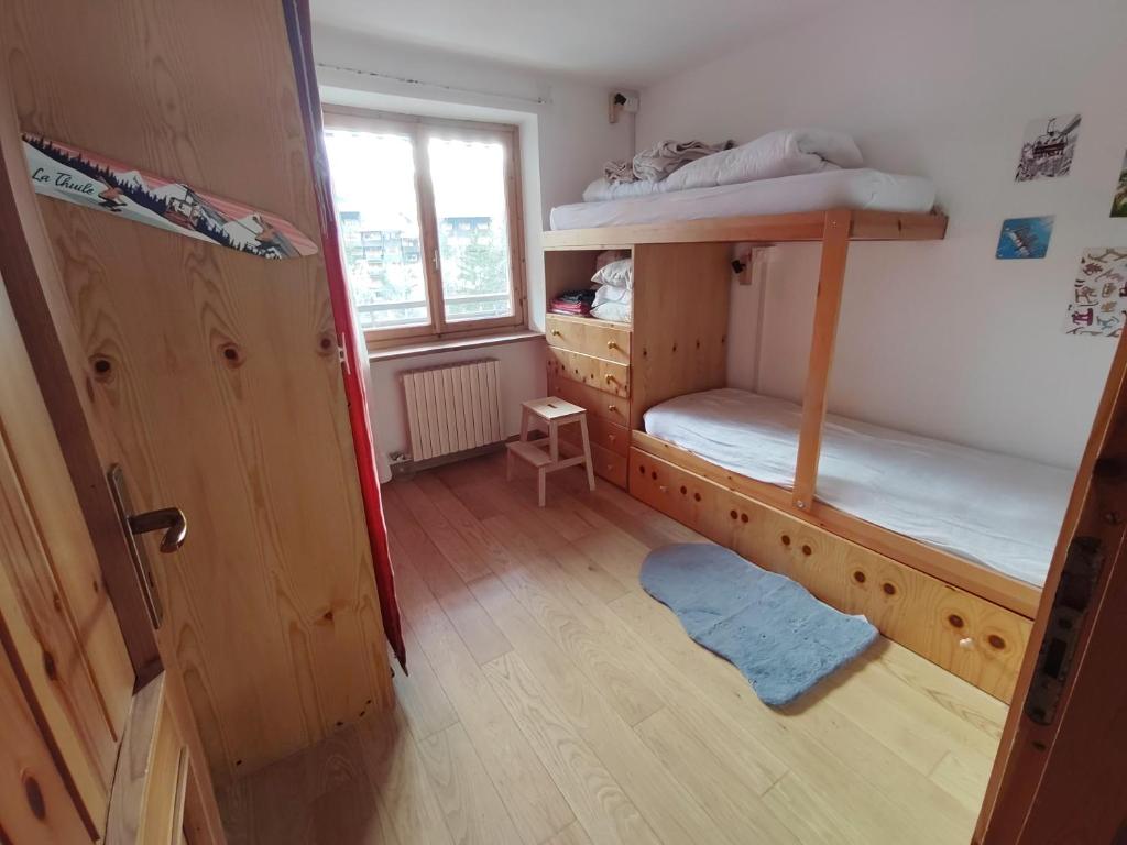 a room with two bunk beds and a window at La MaisonB - Arly in La Thuile