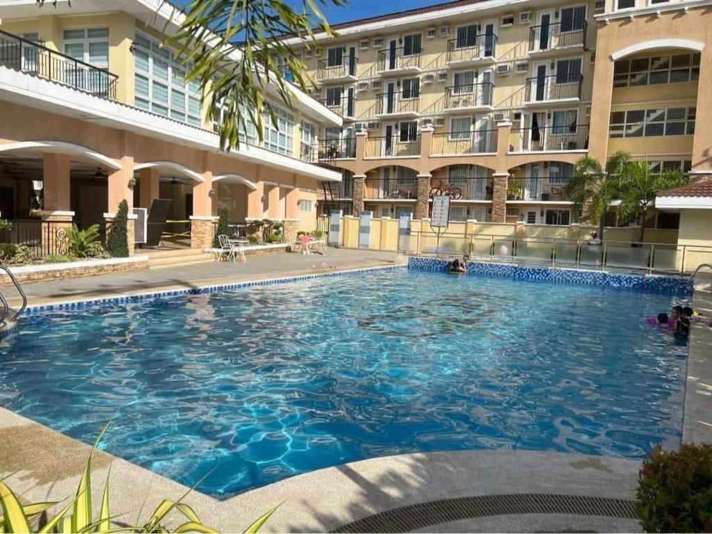 a large swimming pool in front of a building at Arezzo Davao GZJ condotelle 300mbps wifi in Davao City