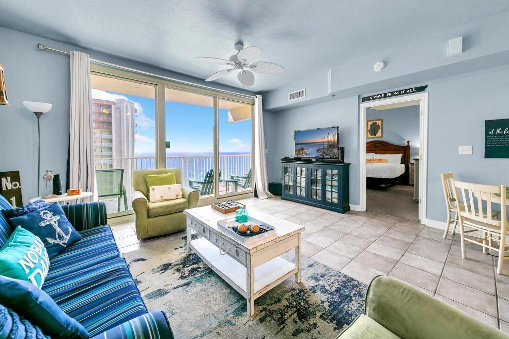 a living room with a couch and a table at Shores of Panama 1816 in Panama City Beach