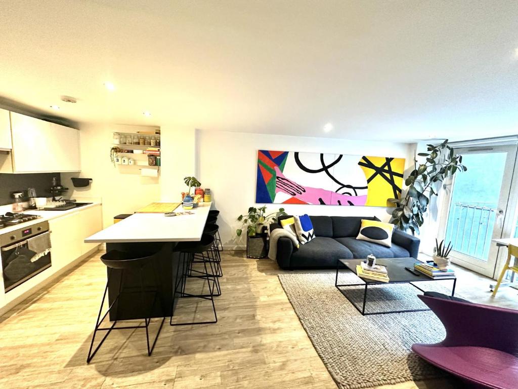 a kitchen and living room with a couch and a table at The Hoxton Nest - Shoreditch in London