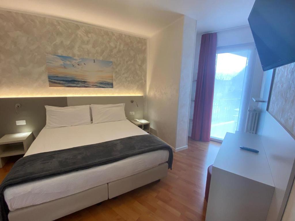 Postel nebo postele na pokoji v ubytování Hotel Angelini