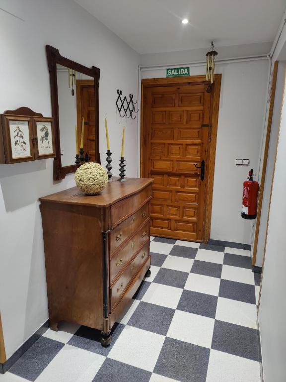 a room with a wooden dresser and a door at Casa Baire in Puigmoreno