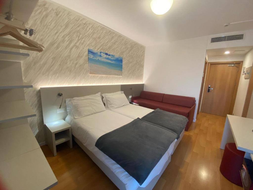 Postel nebo postele na pokoji v ubytování Hotel Angelini