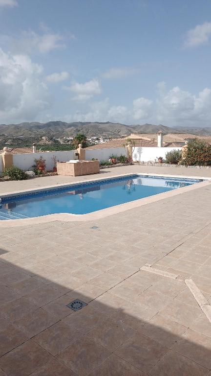 a swimming pool in the middle of a patio at Bonita Casita Luz del Sol in Arboleas