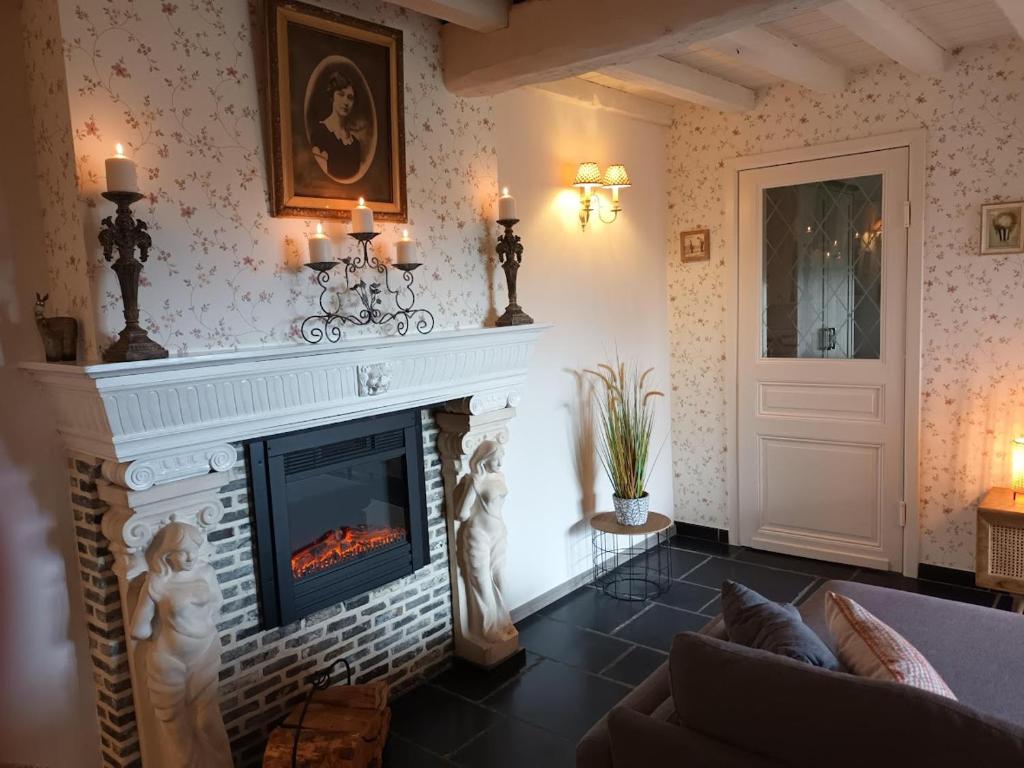 a living room with a fireplace with a fire place at DE LANDSHOEVE vakantiewoningen in Zwalm