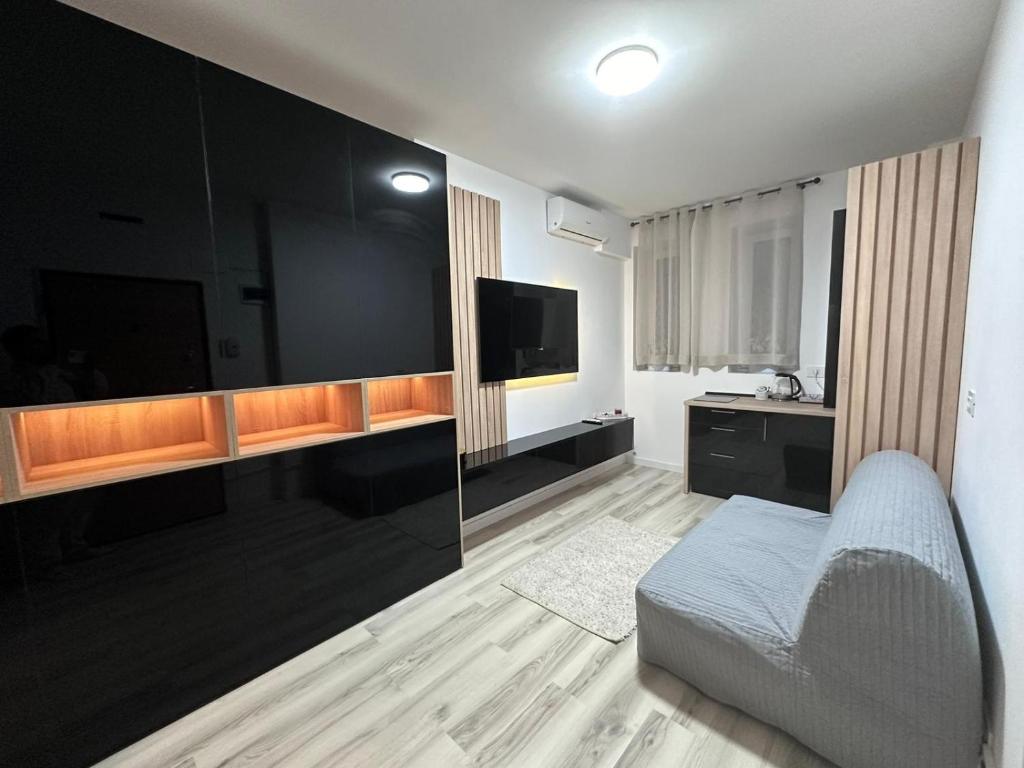 a living room with a couch and a flat screen tv at Luxury 1 bedroom apartment in Bucharest