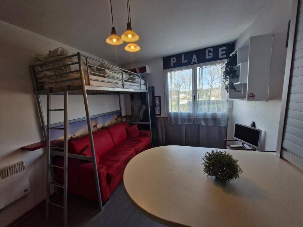 een woonkamer met een stapelbed en een tafel bij Studio RDC - Marina 4 - 13 allée des Pinons - 0-1 in Saint-Jean-de-Monts