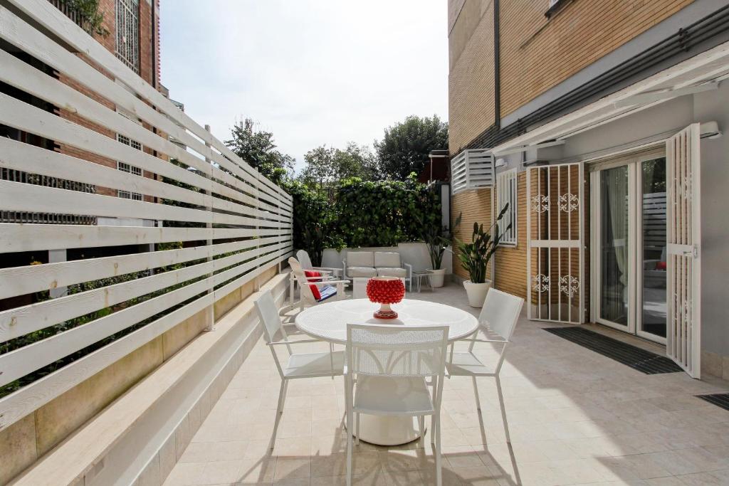 a patio with a white table and chairs at Casa Dolce Casa in Rome