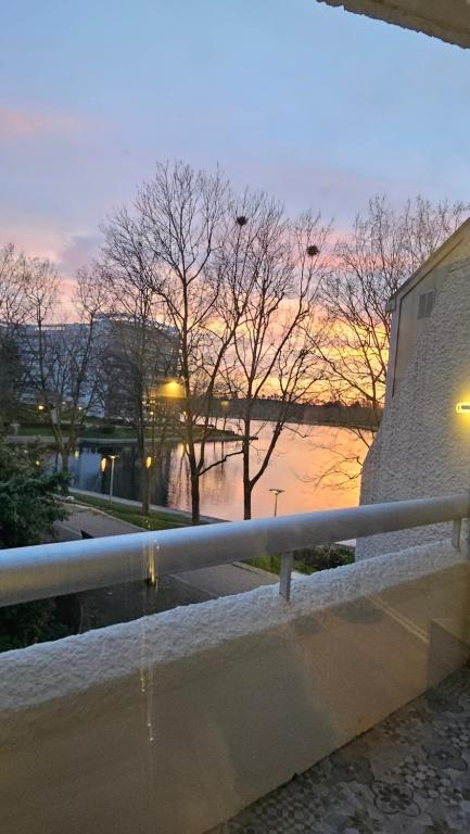 a view of a river at sunset from a bridge at The Lake House rooms - 20 min to Paris by metro in Créteil