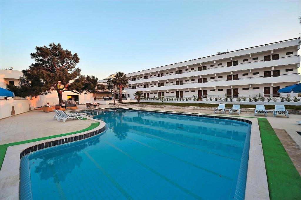 a large swimming pool in front of a building at SOZ HOTEL in Bodrum City