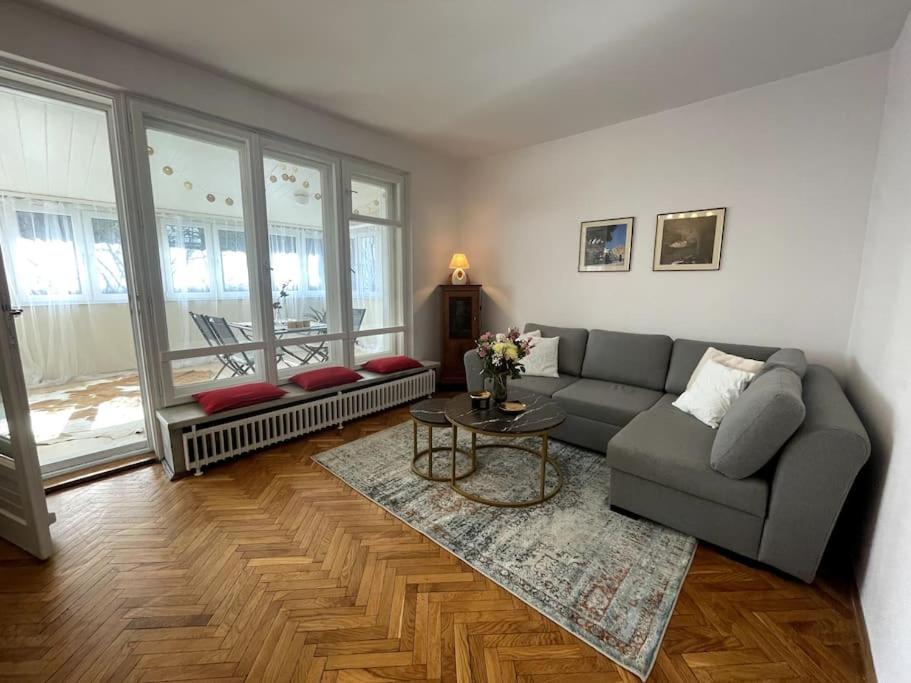 a living room with a couch and a table at Cracow Heart Apartment in Krakow