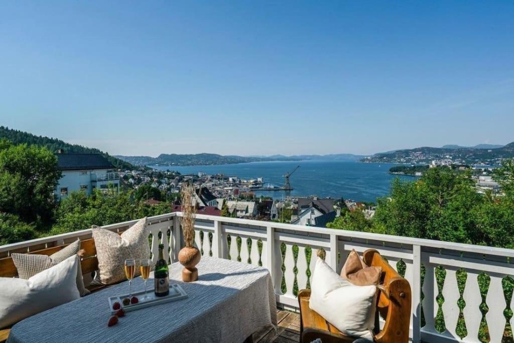 a table on a balcony with a view of the water at Villa with incredible view, 5 BR in Bergen