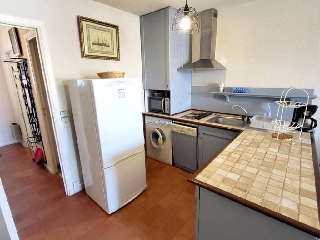 a kitchen with a white refrigerator and a sink at Appartement Six-Fours-les-Plages, 2 pièces, 5 personnes - FR-1-316-118 in Six-Fours-les-Plages