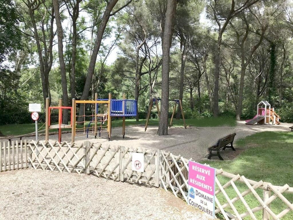 a park with a playground with a fence at Appartement Six-Fours-les-Plages, 2 pièces, 5 personnes - FR-1-316-118 in Six-Fours-les-Plages