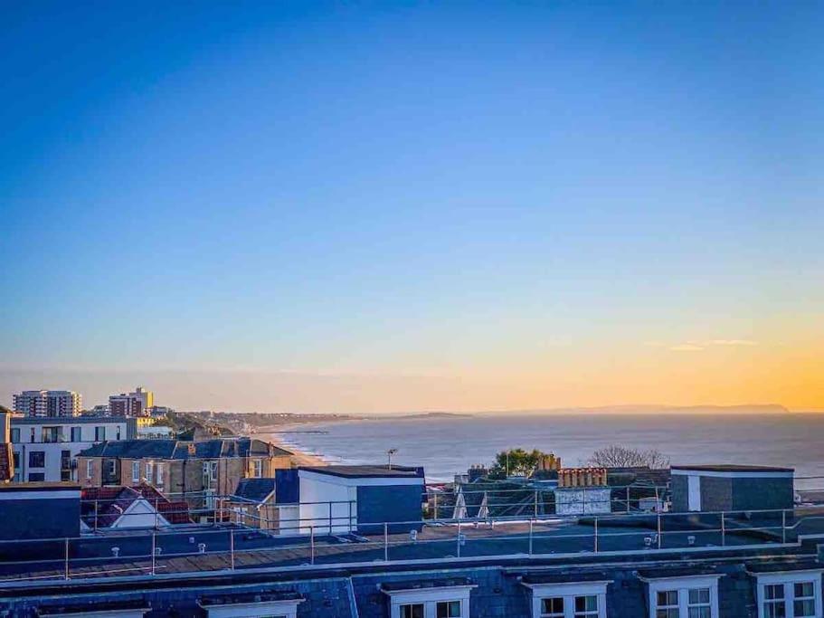a view of a city with the ocean and buildings at Beach Penthouse Apartment Bournemouth in Bournemouth
