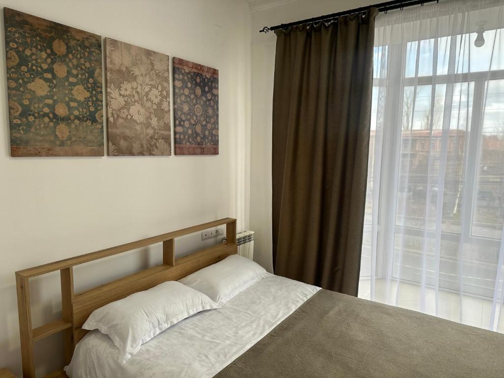 a bedroom with a bed in front of a window at Mtour Apartment in Gyumri