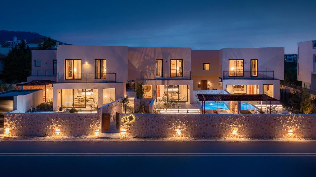 a building with lights in front of it at night at Nisi Living Concept in Ialyssos