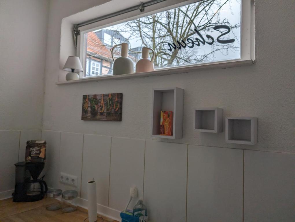 a window with vases on top of cabinets in a room at Studio Ahnatal in Weimar