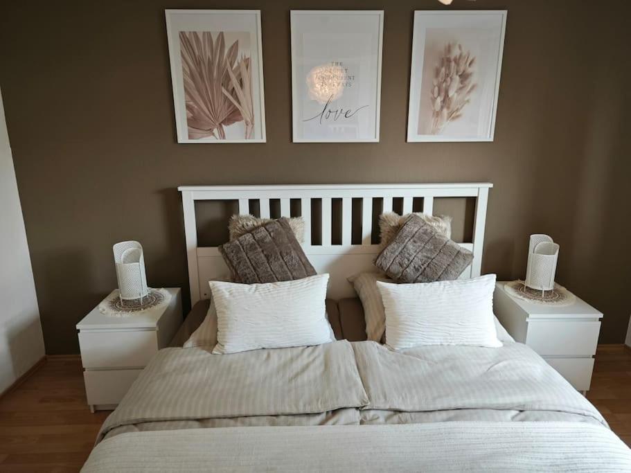 a bedroom with a large bed with two night stands at 3 Zimmer Ferienwohnung 80qm in Bamberg