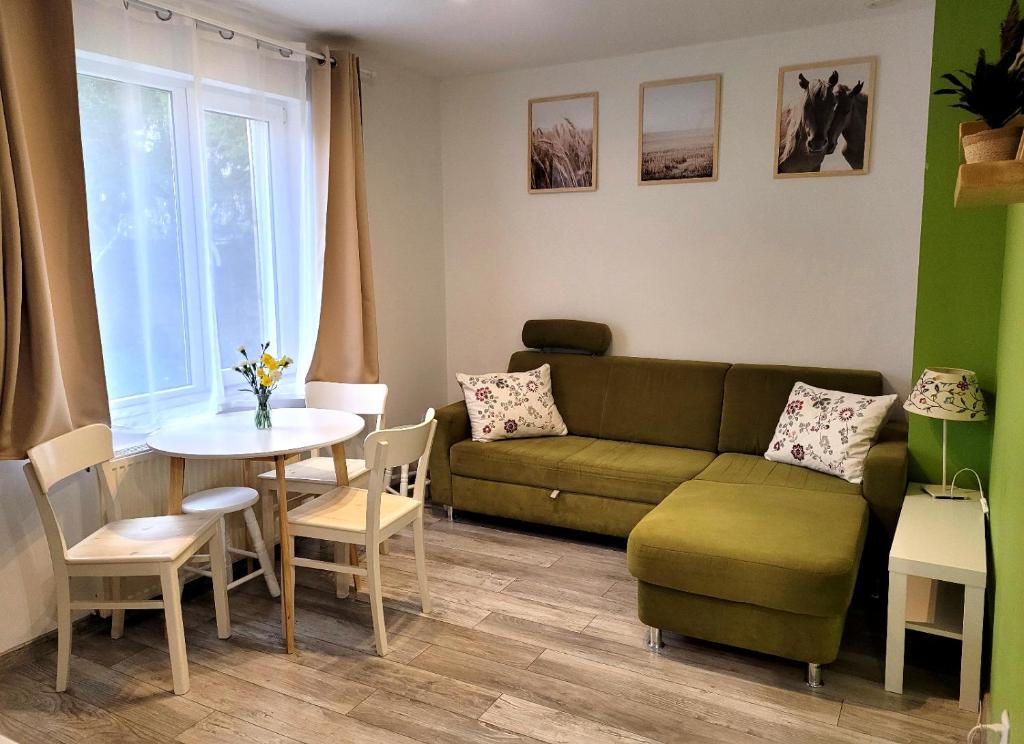 a living room with a couch and a table at Ferienwohnung Wolin Ostsee Insel Misdroy in Wolin