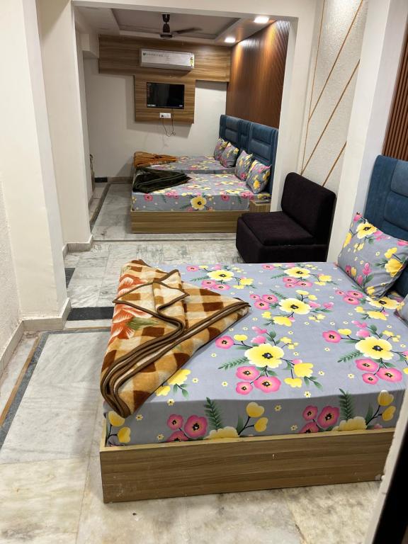 a room with two beds with flowers on it at HOTEL DIVYA in Rishīkesh