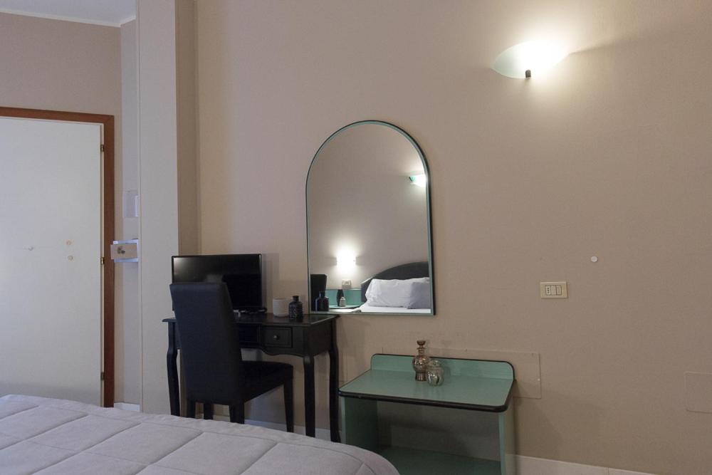 A bed or beds in a room at Hotel Trevi Riccione, in centro sul mare con cucina