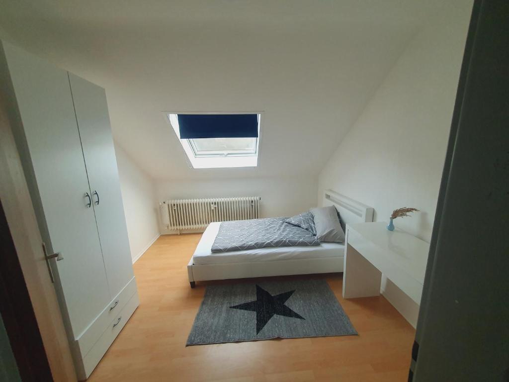 a small bedroom with a bed and a skylight at Ferienwohnung Haßberge in Knetzgau