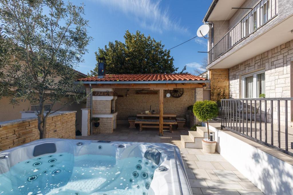 a hot tub on the patio of a house at House Roko in Dramalj