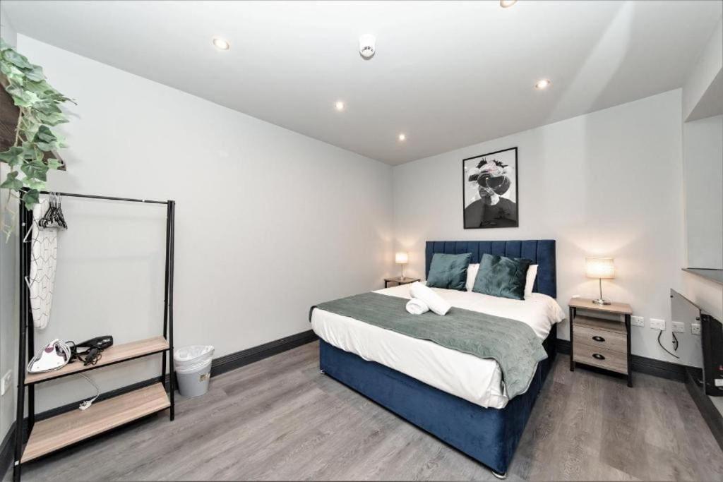 a bedroom with a large bed and a mirror at Ship Street 1 bedroom/ seafront in Brighton & Hove