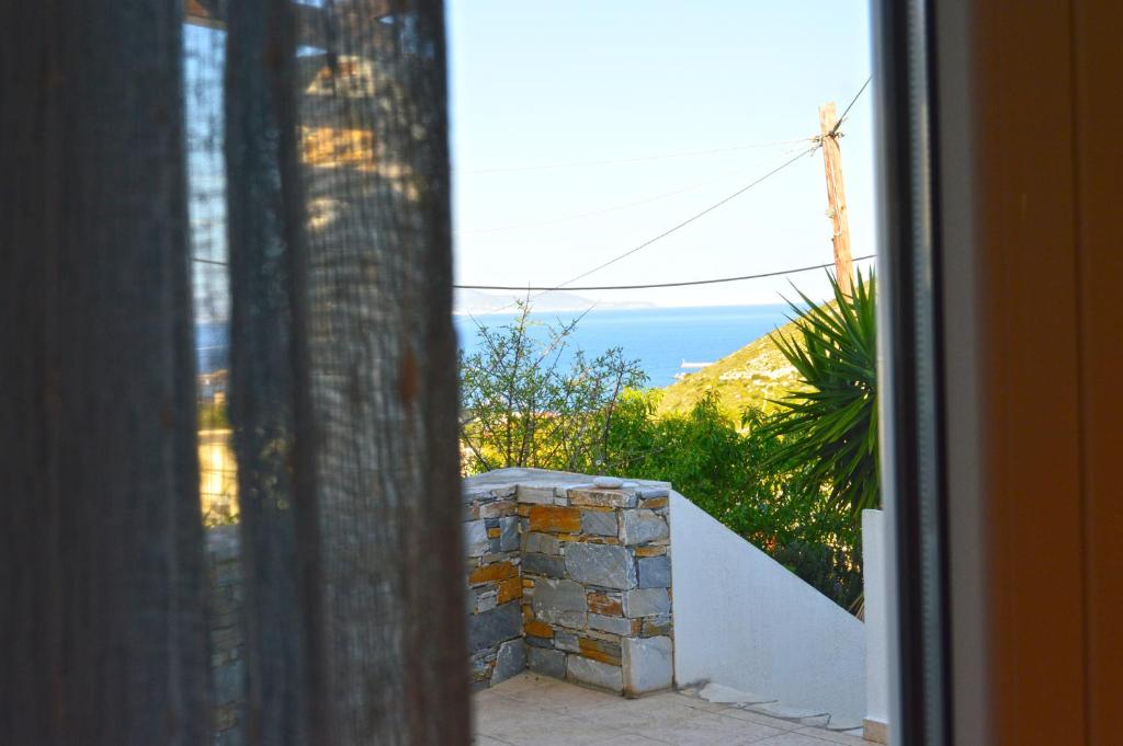 a view of the ocean from a window at SunShine House in Ermoupoli