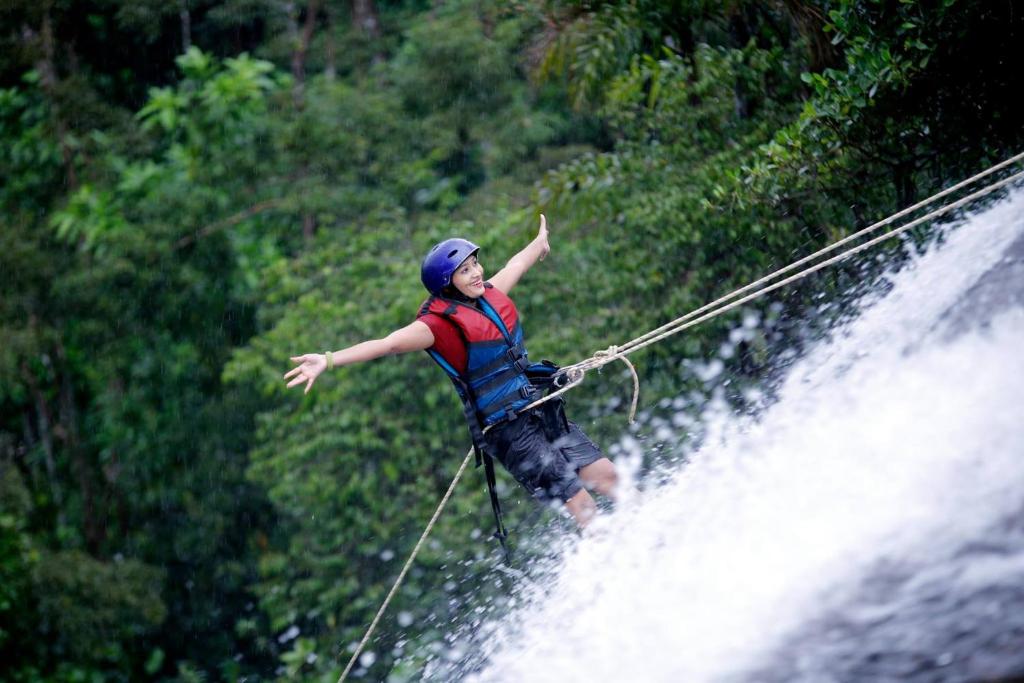 a person on a rope on a waterfall at Ceylon Adventure Sports in Kitulgala