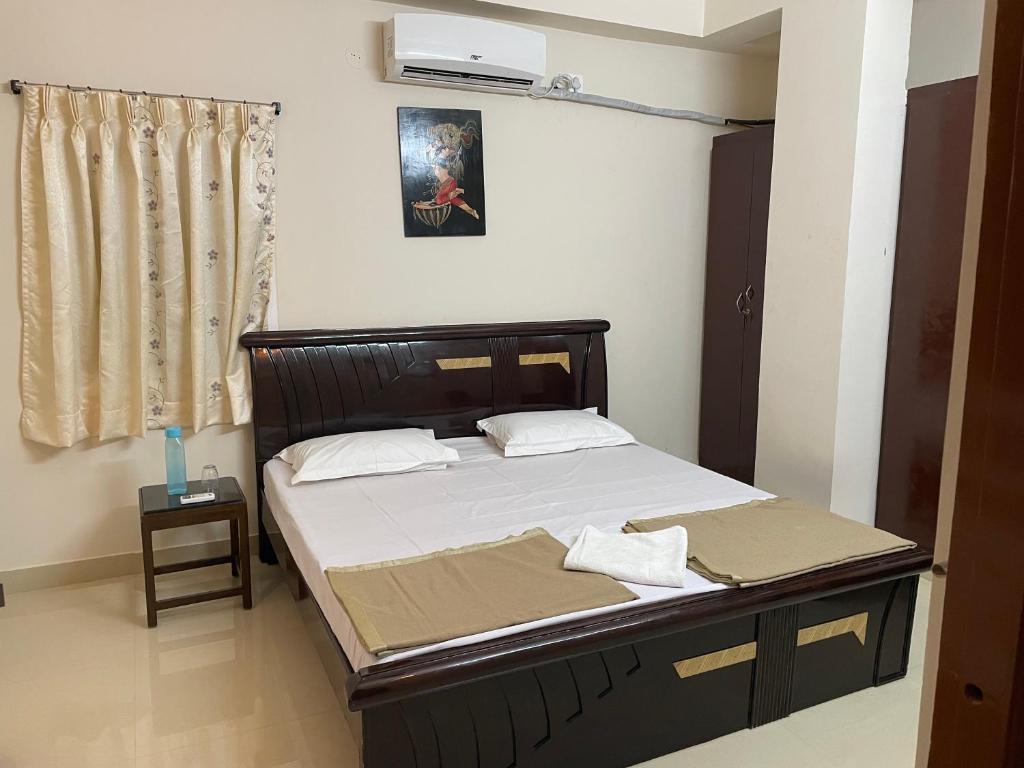 1 dormitorio con 1 cama grande con sábanas blancas en Dpinn homestay, en Hyderabad