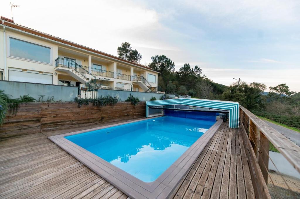 a swimming pool on the deck of a house at Casas Ponte D'Alge in Foz de Alge