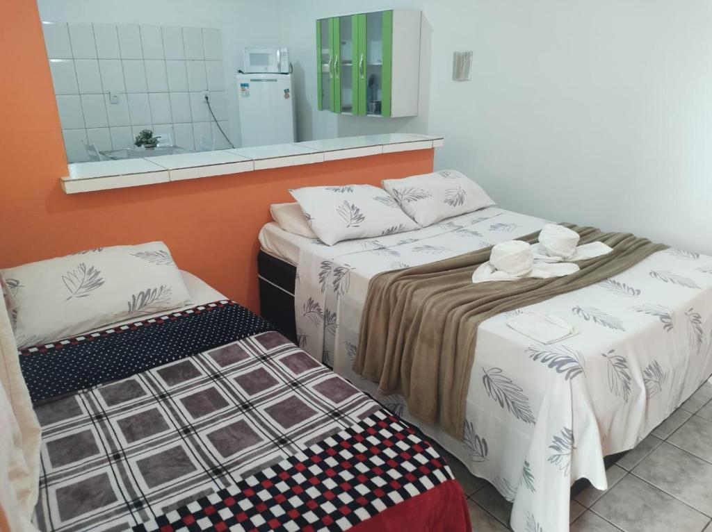 two beds sitting next to each other in a room at Apartamento em Angra dos Reis in Angra dos Reis