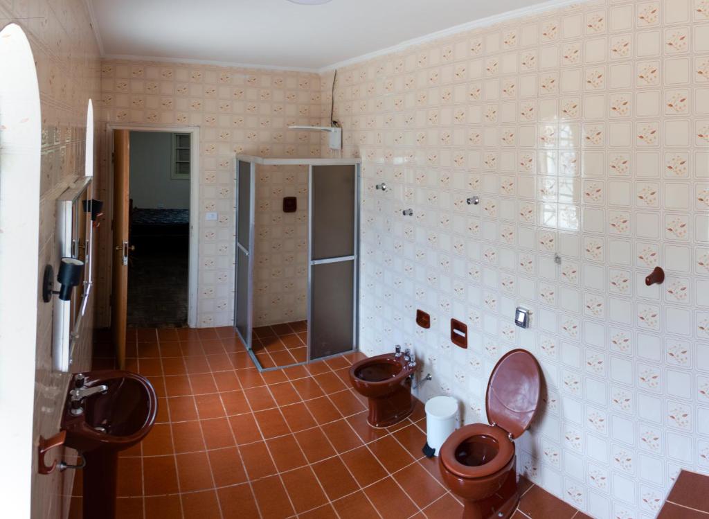 a bathroom with two toilets and two sinks at Elysian Place in Atibaia