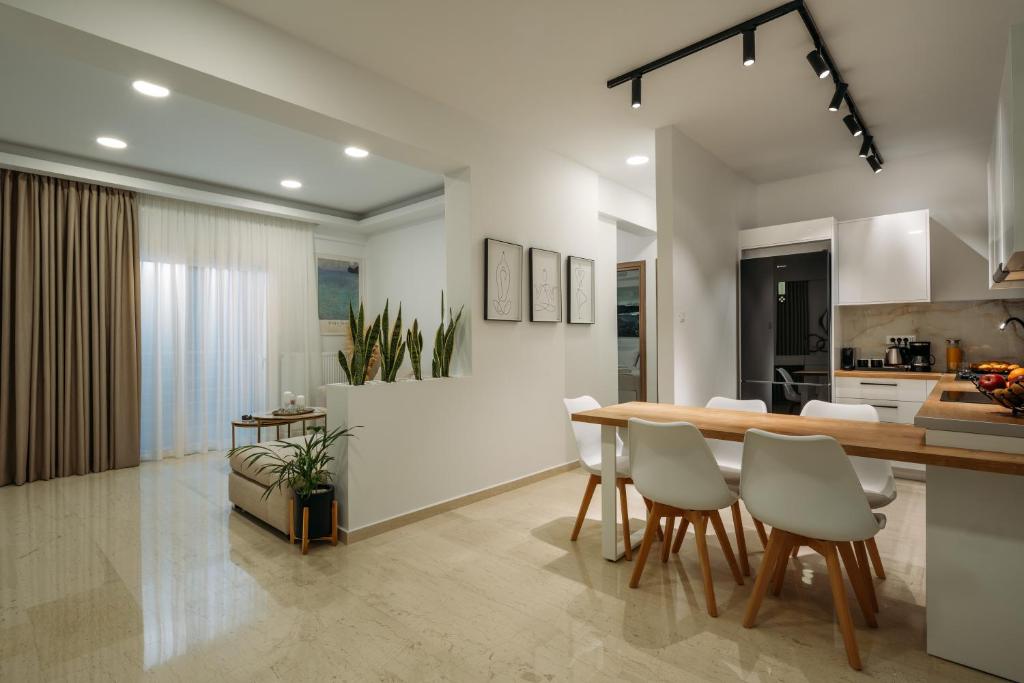 a kitchen and dining room with a table and chairs at ELiXiR 2 Luxury apartments in Agios Nikolaos