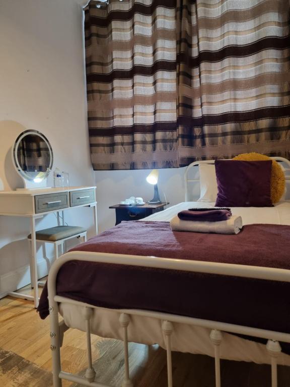 a bedroom with a bed and a window at The Windmill Hotel in London