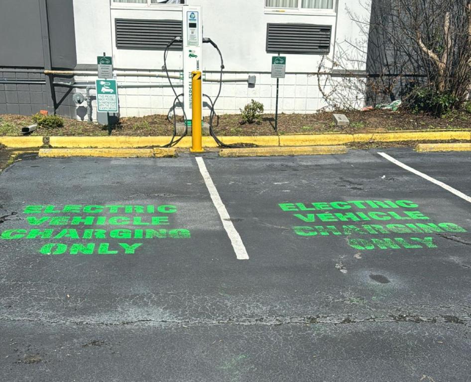an empty parking lot with green writing on the street at Sleep Inn - Salisbury I-85 in Salisbury
