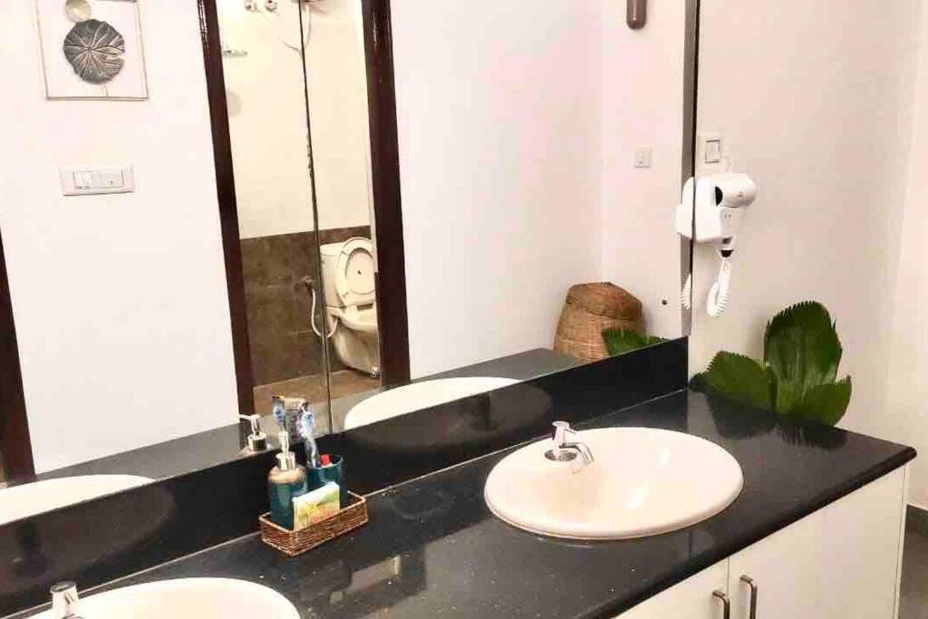 a bathroom with two sinks and a large mirror at Nandi Private Residence, Bohemian Hill View Villa in Devanahalli-Bangalore