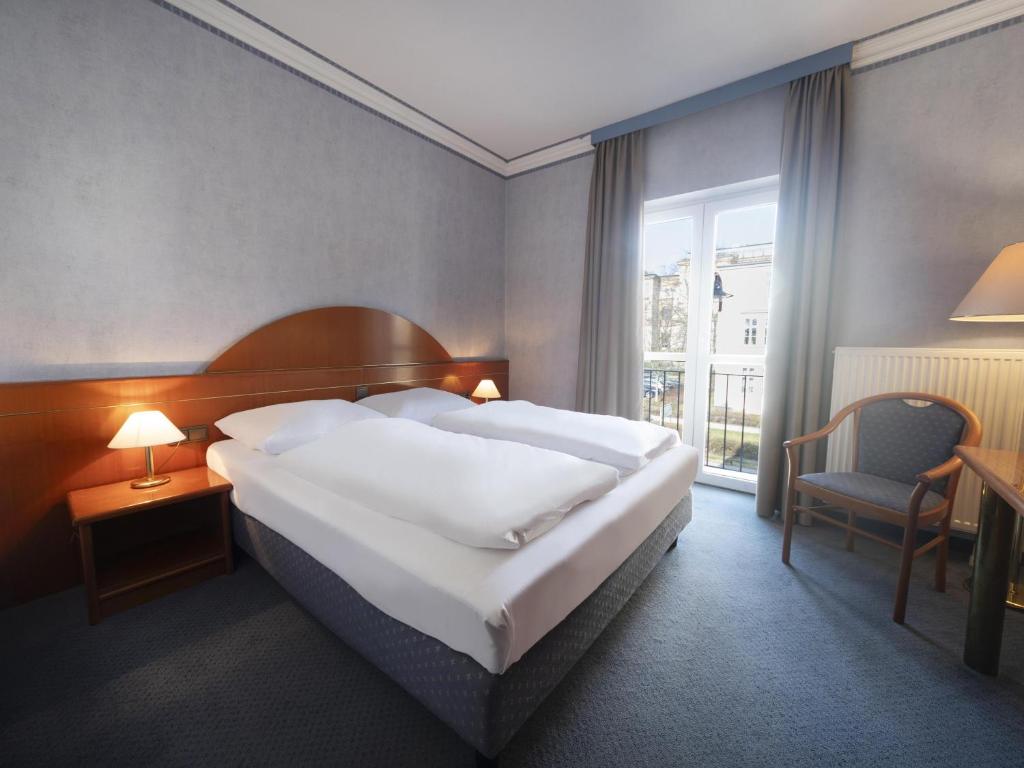 Voodi või voodid majutusasutuse B&B HOTEL Gotha-Hbf toas