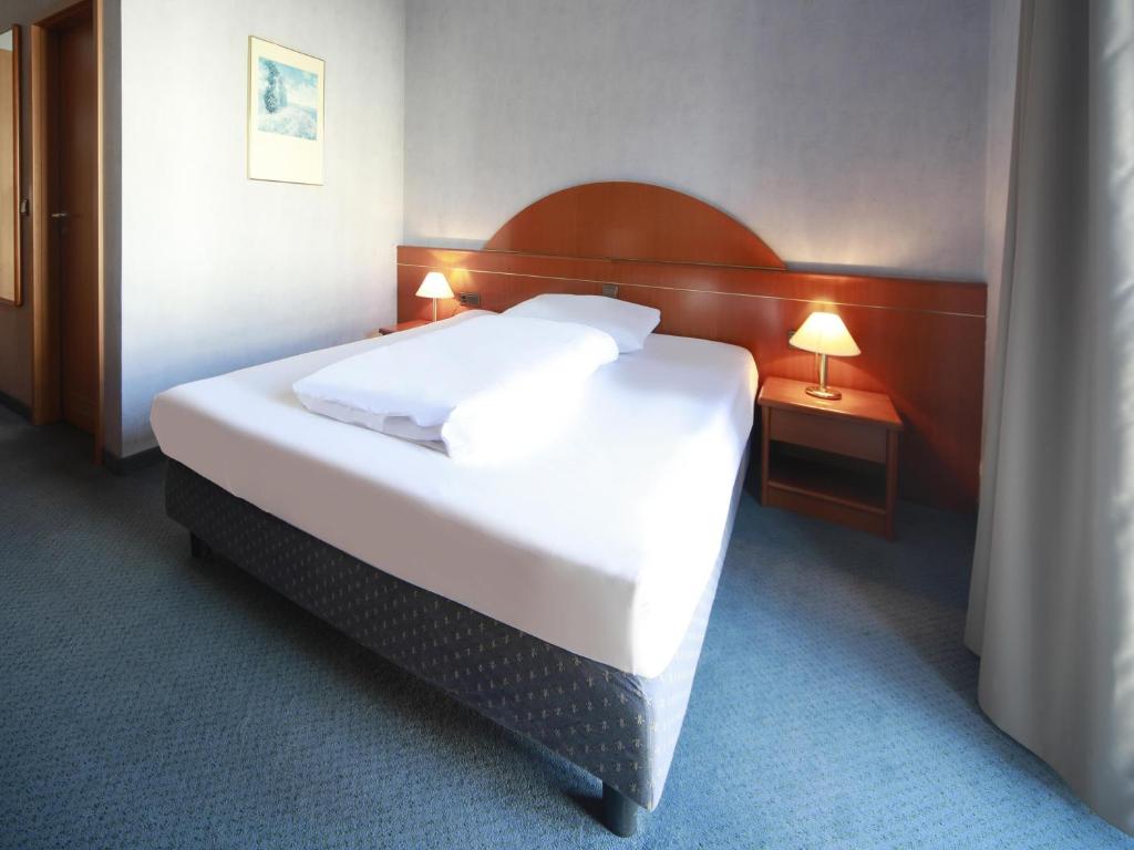 Voodi või voodid majutusasutuse B&B HOTEL Gotha-Hbf toas