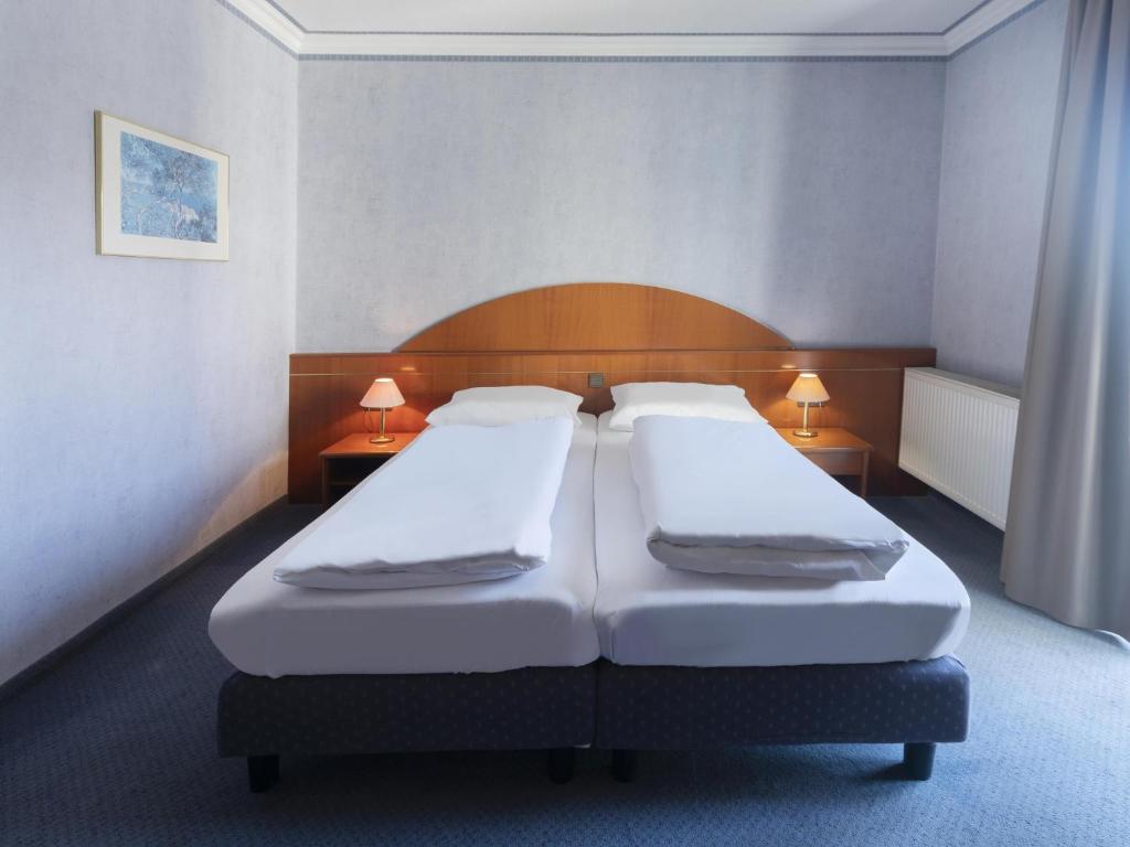 Voodi või voodid majutusasutuse B&B HOTEL Gotha-Hbf toas