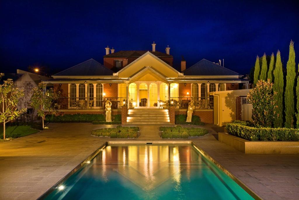 a house with a swimming pool in front of a house at Freeman On Ford in Beechworth