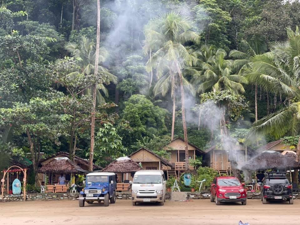 a group of cars parked in front of a resort at A&Z Nagtabon Lodge in Bacungan